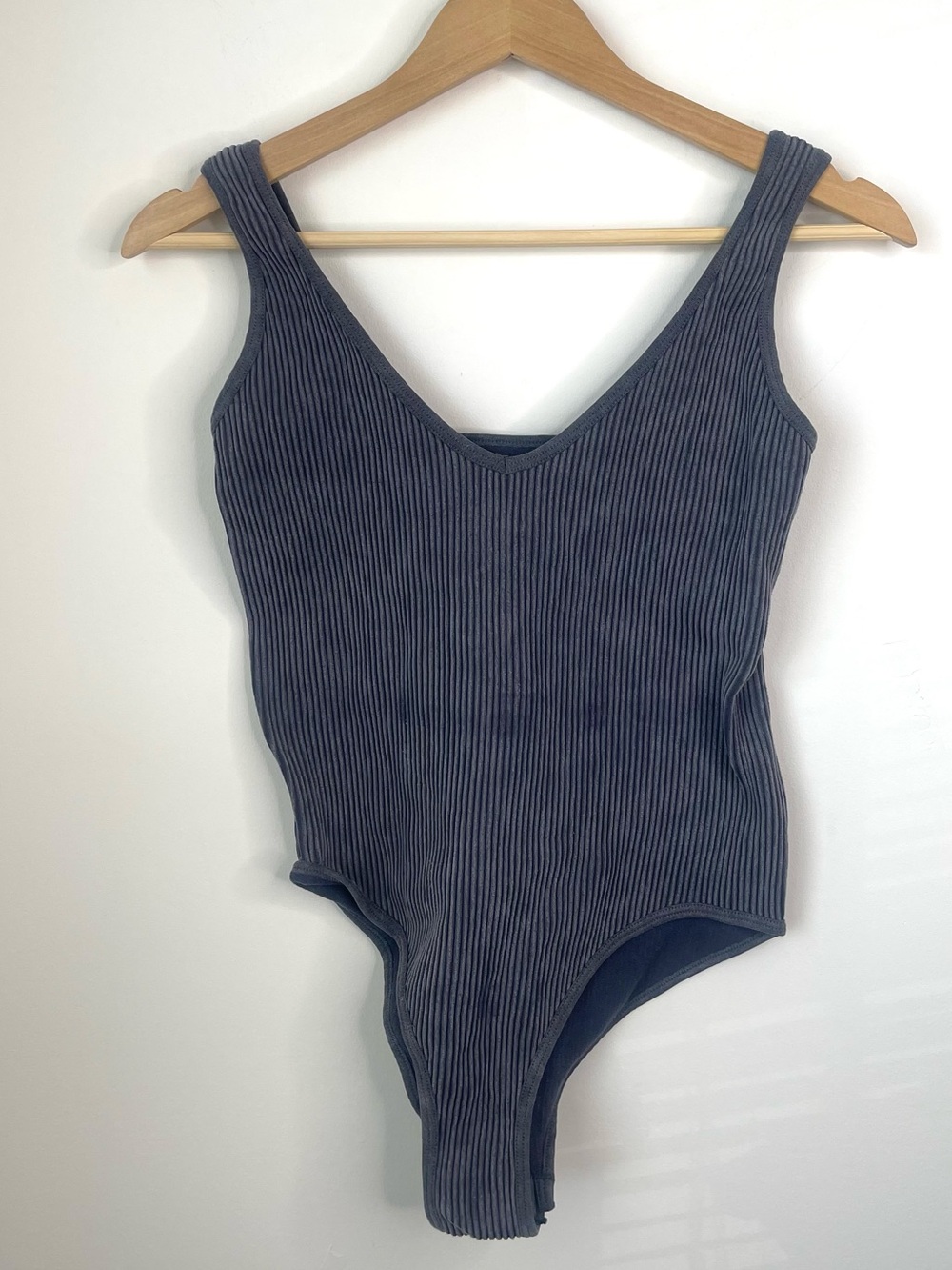 Aura bodysuit features a textured ribbed knit design with a v-neckline L/XL